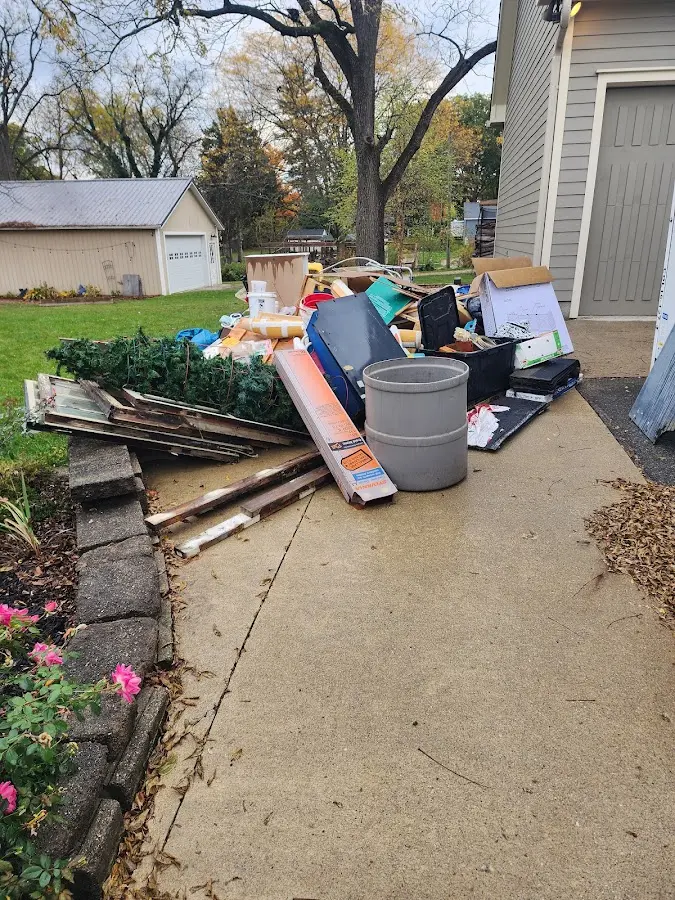 Dumpster being loaded with debris for Roofing Dumpster Rental in Poinciana